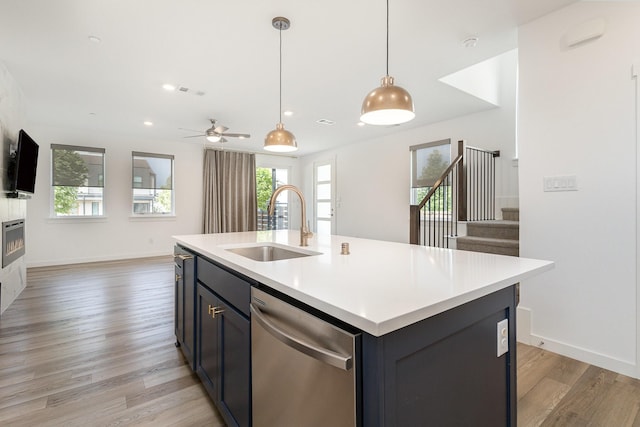 913 Emerling Dr, Mckinney, TX 75069 - kitchen with a sink, stainless steel dishwasher, light countertops, light wood-type flooring, and healthy amount of natural light