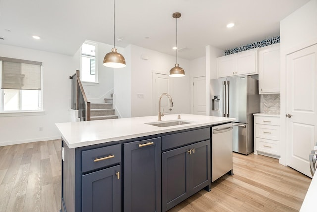 913 Emerling Dr, Mckinney, TX 75069 - kitchen with appliances with stainless steel finishes, a sink, white cabinets, light countertops, and recessed lighting