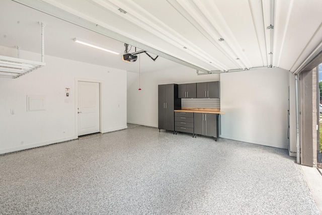 913 Emerling Dr, Mckinney, TX 75069 - garage featuring a garage door opener and baseboards