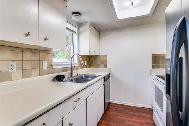 1826 Mercury Dr, Garland, TX 75040 - kitchen featuring stainless steel appliances, a sink, white cabinets, dark wood finished floors, and light countertops