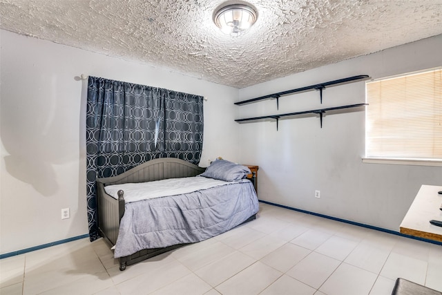 1826 Mercury Dr, Garland, TX 75040 - bedroom featuring a textured ceiling and baseboards