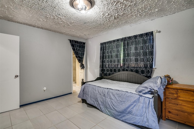 1826 Mercury Dr, Garland, TX 75040 - tiled bedroom featuring a textured ceiling