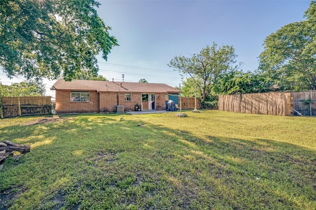 1826 Mercury Dr, Garland, TX 75040 - rear view of house featuring central AC unit, brick siding, and a patio