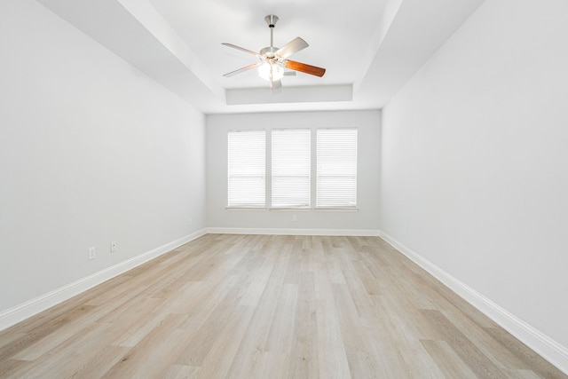 1211 Templin Ave, Forney, TX 75126 - spare room with a tray ceiling, a ceiling fan, light wood-style flooring, and baseboards
