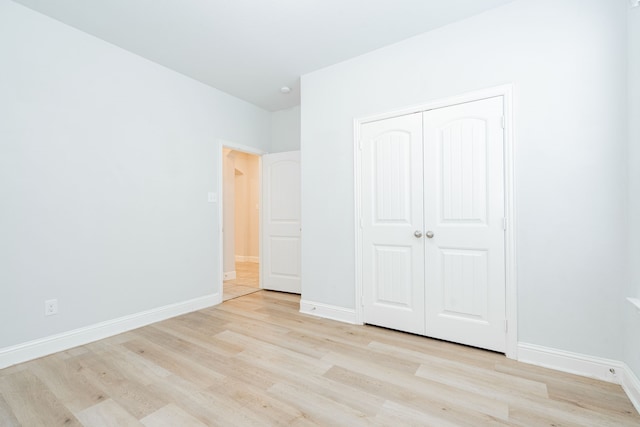 1211 Templin Ave, Forney, TX 75126 - unfurnished bedroom with light wood-style flooring, baseboards, and a closet