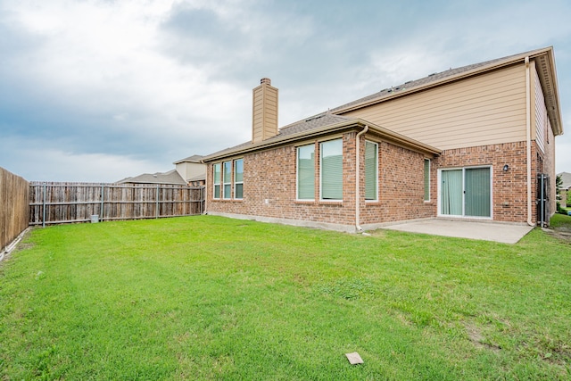 1211 Templin Ave, Forney, TX 75126 - back of house featuring a chimney, brick siding, and a patio