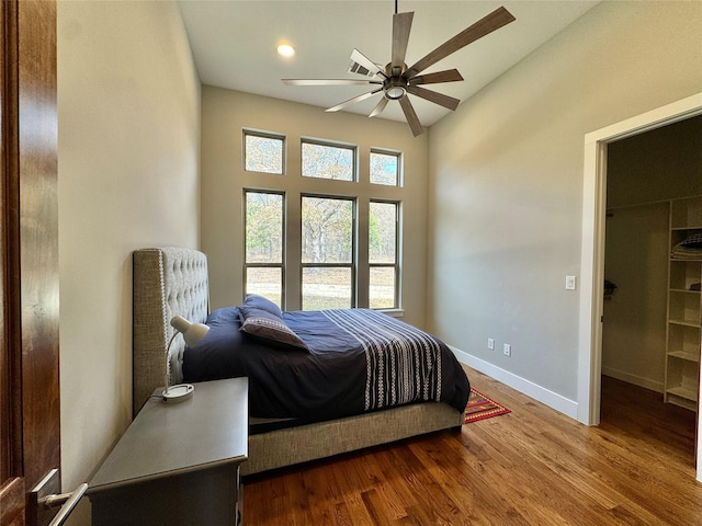 474 Eagle Cove Cir, Tioga, TX 76271 - bedroom featuring wood finished floors, baseboards, a walk in closet, and a ceiling fan