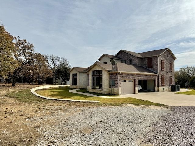 474 Eagle Cove Cir, Tioga, TX 76271 - view of front of home with brick siding, driveway, a garage, central AC, and a front lawn