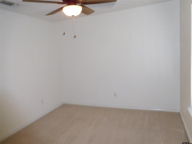 405 Cherry St, Chandler, TX 75758 - unfurnished room with ceiling fan, light carpet, and baseboards