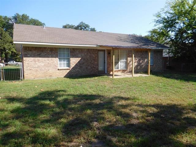 405 Cherry St, Chandler, TX 75758 - back of house featuring brick siding and a patio area