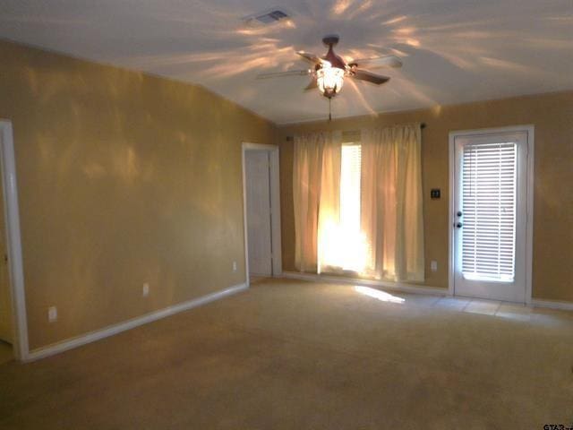 405 Cherry St, Chandler, TX 75758 - empty room featuring ceiling fan, baseboards, light colored carpet, and vaulted ceiling