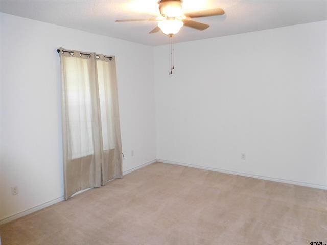 405 Cherry St, Chandler, TX 75758 - spare room featuring a ceiling fan, light carpet, and baseboards
