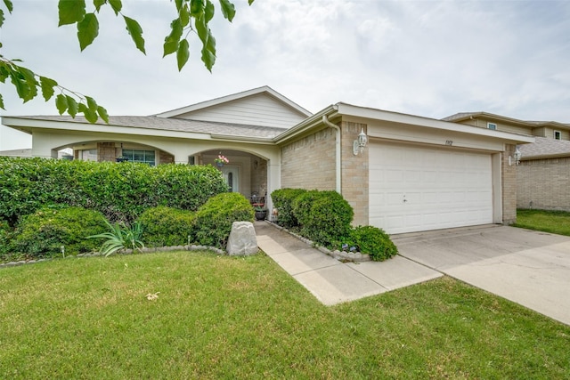 1312 Dakota Trl, Krum, TX 76249 - view of front of property with an attached garage, brick siding, concrete driveway, and a front lawn