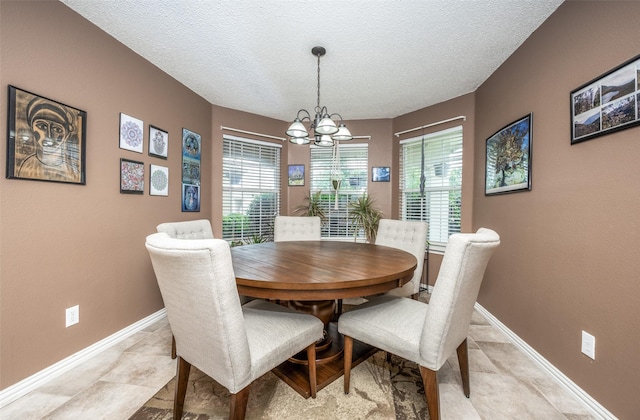 1312 Dakota Trl, Krum, TX 76249 - dining space featuring a chandelier, a textured ceiling, and baseboards