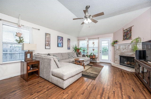 1312 Dakota Trl, Krum, TX 76249 - living room featuring vaulted ceiling, hardwood / wood-style flooring, a brick fireplace, ceiling fan, and baseboards