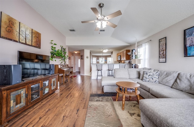 1312 Dakota Trl, Krum, TX 76249 - living room with light wood-type flooring, a ceiling fan, lofted ceiling, and a textured ceiling
