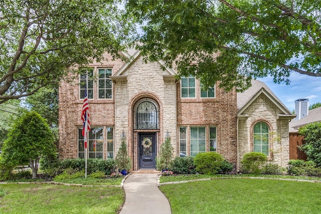 5001 Stanford Ave, Dallas, TX 75209 - view of front of house with a front yard, stone siding, and brick siding