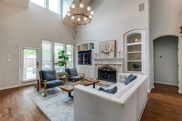 5001 Stanford Ave, Dallas, TX 75209 - living room featuring a high ceiling, dark wood-style floors, a stone fireplace, baseboards, and arched walkways