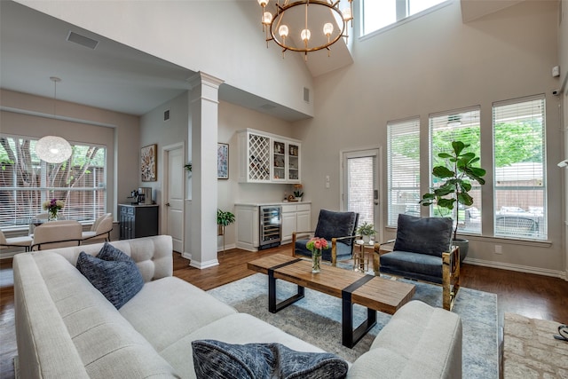 5001 Stanford Ave, Dallas, TX 75209 - living room with wine cooler, a dry bar, a chandelier, wood finished floors, and a towering ceiling