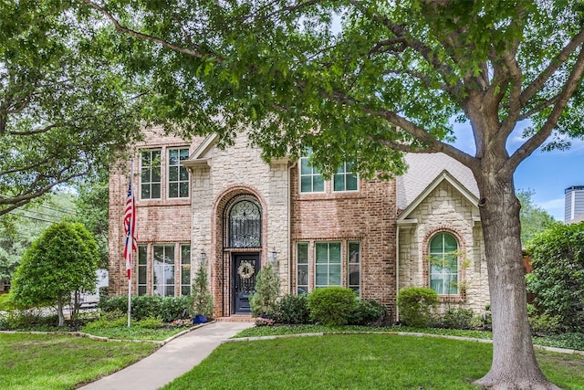 5001 Stanford Ave, Dallas, TX 75209 - traditional home with a front lawn, stone siding, and brick siding