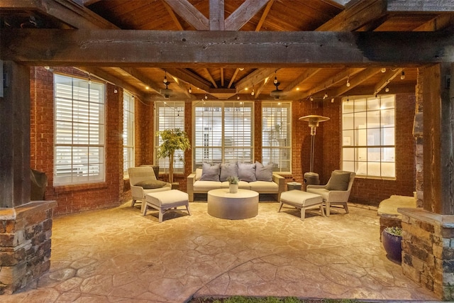 2906 Cottonwood Ln, Colleyville, TX 76034 - living area featuring wood ceiling with exposed beams, stone flooring, and brick wall