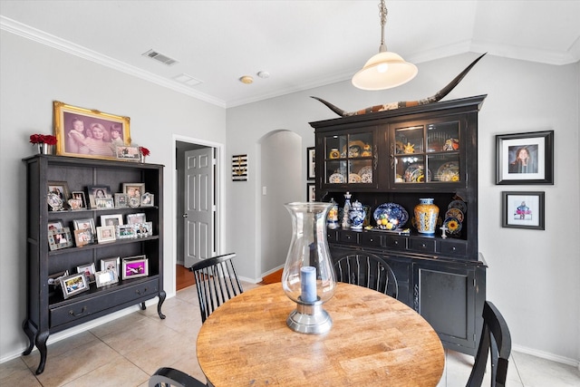 2411 Ravenwood Ct, Mansfield, TX 76063 - dining room featuring arched walkways, light tile patterned flooring, crown molding, and baseboards