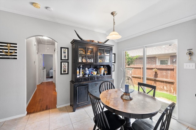 2411 Ravenwood Ct, Mansfield, TX 76063 - dining space featuring arched walkways, ornamental molding, baseboards, and light tile patterned floors