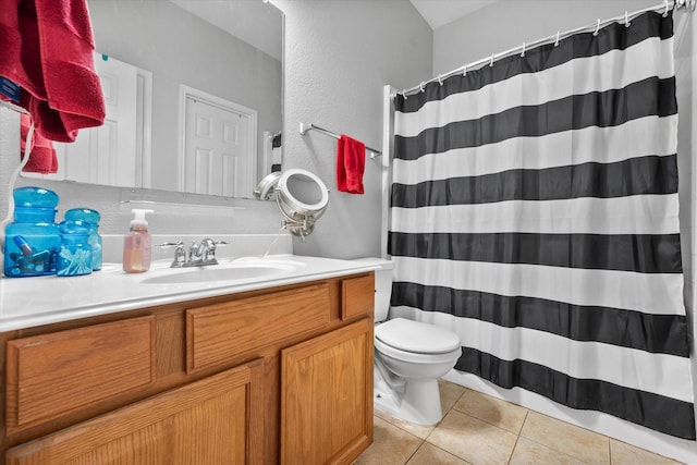 2411 Ravenwood Ct, Mansfield, TX 76063 - bathroom featuring toilet, vanity, tile patterned flooring, a textured wall, and a shower with curtain