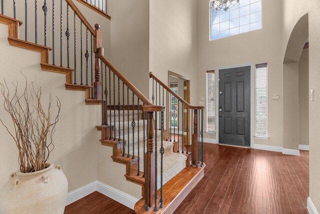 9772 Hickory St, Frisco, TX 75035 - stairway featuring a towering ceiling, wood finished floors, baseboards, ornamental molding, and a fireplace
