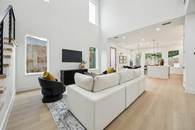 5217 Lindsley Ave, Dallas, TX 75223 - living room with light wood-type flooring, baseboards, a towering ceiling, and recessed lighting