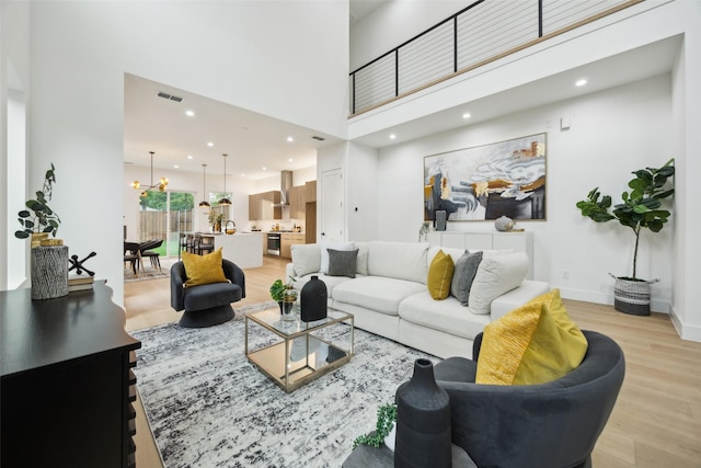 5217 Lindsley Ave, Dallas, TX 75223 - living room with light wood finished floors, a towering ceiling, and recessed lighting