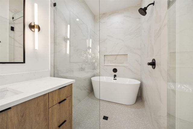 5217 Lindsley Ave, Dallas, TX 75223 - bathroom with vanity, a shower, a freestanding bath, tile walls, and tile patterned flooring