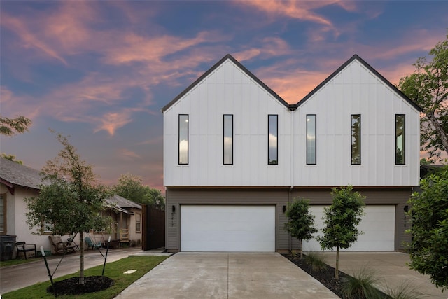 5217 Lindsley Ave, Dallas, TX 75223 - view of front of house with an attached garage, board and batten siding, and concrete driveway