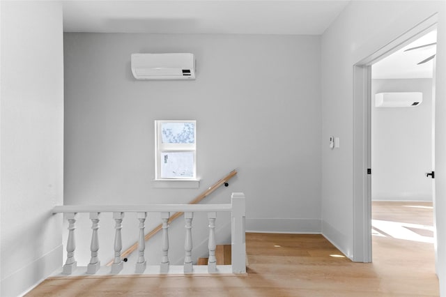 511 W Munson St, Denison, TX 75020 - stairs with a wall mounted AC, wood finished floors, and baseboards