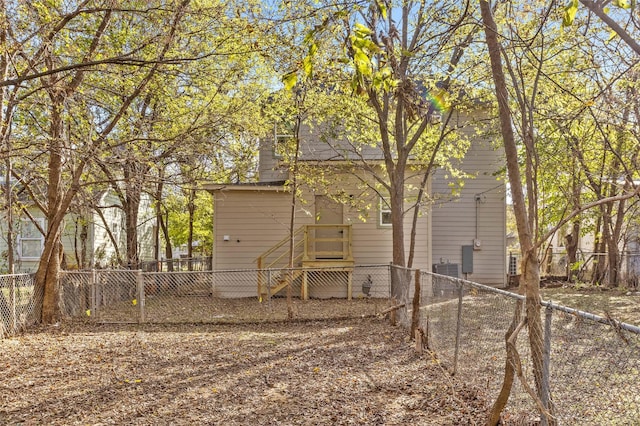 511 W Munson St, Denison, TX 75020 - back of house with a chimney and a fenced backyard