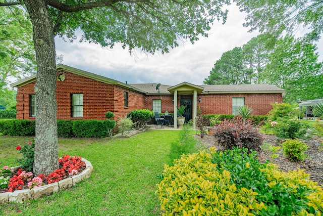 350 Vz County Road 3907, Wills Point, TX 75169 - ranch-style house featuring a front yard, brick siding, and a patio