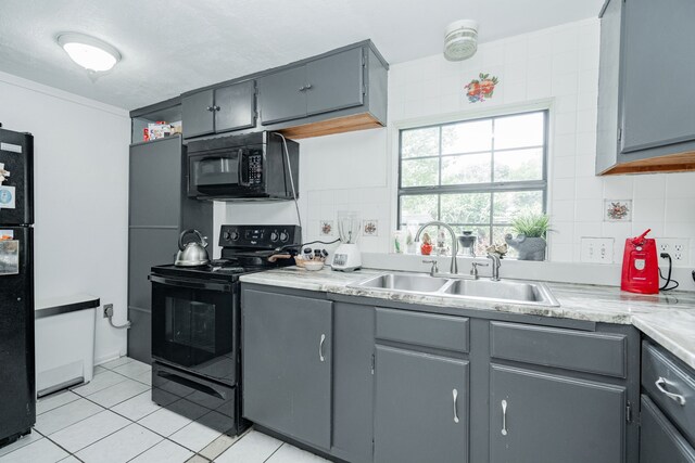 350 Vz County Road 3907, Wills Point, TX 75169 - kitchen with black appliances, a sink, light tile patterned floors, gray cabinets, and light countertops