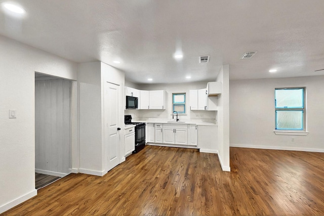 3920 Vanette Ln, Dallas, TX 75216 - kitchen featuring black appliances, a sink, light countertops, baseboards, and recessed lighting