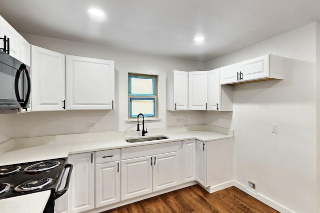 3920 Vanette Ln, Dallas, TX 75216 - kitchen featuring a sink, black microwave, electric range oven, dark wood-style flooring, and white cabinetry
