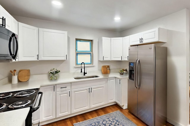 3920 Vanette Ln, Dallas, TX 75216 - kitchen with stainless steel fridge, a sink, black microwave, electric range, and light countertops