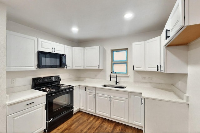 3920 Vanette Ln, Dallas, TX 75216 - kitchen featuring black appliances, a sink, white cabinetry, dark wood-style flooring, and recessed lighting