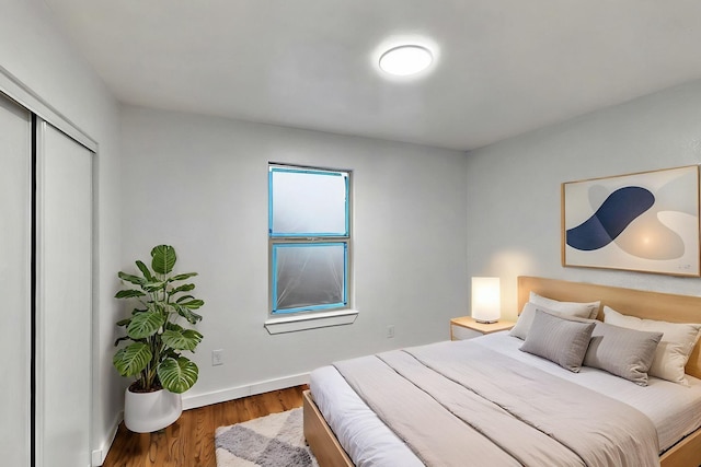 3920 Vanette Ln, Dallas, TX 75216 - bedroom with wood finished floors, a closet, and baseboards