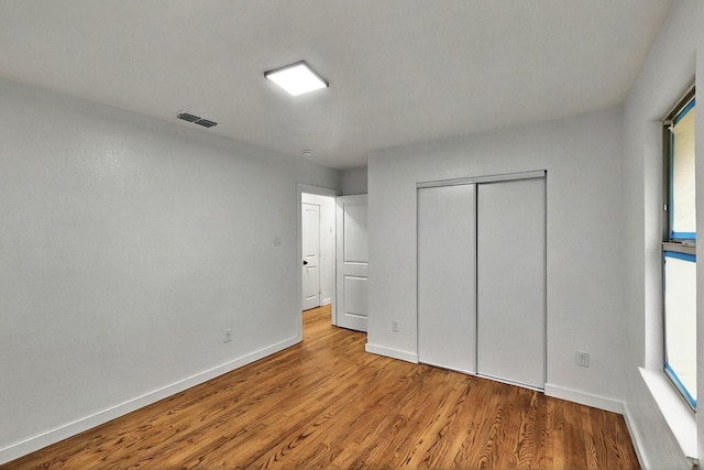 3920 Vanette Ln, Dallas, TX 75216 - unfurnished bedroom featuring wood finished floors, baseboards, and a closet
