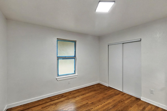 3920 Vanette Ln, Dallas, TX 75216 - unfurnished bedroom featuring wood finished floors, baseboards, and a closet