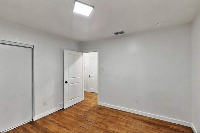 3920 Vanette Ln, Dallas, TX 75216 - unfurnished bedroom featuring baseboards, wood finished floors, and a closet