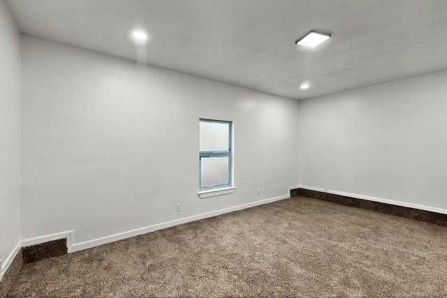 3920 Vanette Ln, Dallas, TX 75216 - empty room with dark carpet, baseboards, and recessed lighting