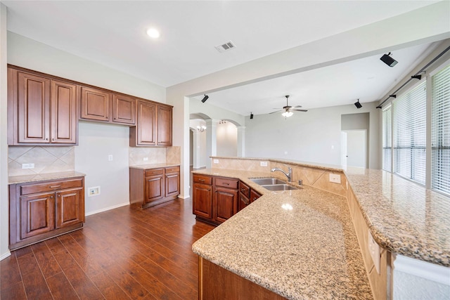 5125 Sugarberry Dr, Mckinney, TX 75071 - kitchen featuring a sink, arched walkways, ornate columns, ceiling fan, and dark wood finished floors