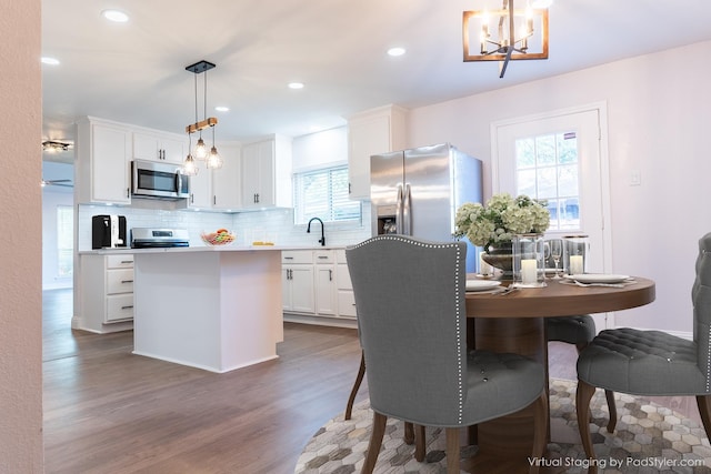 2123 Wheaton Dr, Richardson, TX 75081 - dining room featuring wood finished floors, a chandelier, and recessed lighting