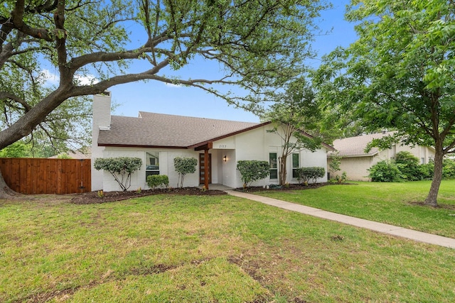 2123 Wheaton Dr, Richardson, TX 75081 - view of front of home with a chimney, stucco siding, and roof with shingles