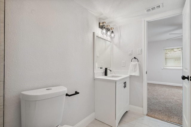 2123 Wheaton Dr, Richardson, TX 75081 - bathroom featuring vanity, toilet, and baseboards